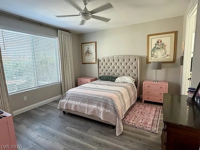 2126 Albury Avenue, North Las Vegas, NV 89086 Plank flooring and a large window with natural light enrich this comfortable bedroom retreat.