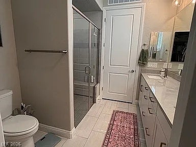 2126 Albury Avenue, North Las Vegas, NV 89086 A glass-enclosed walk-in shower complements the polished vanity in this modern bathroom.