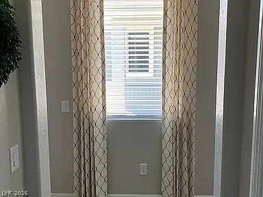 2126 Albury Avenue, North Las Vegas, NV 89086 A tall, narrow window frames views of the neighborhood, providing natural light down the hallway.