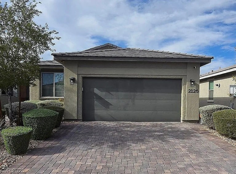 2126 Albury Avenue, North Las Vegas, NV 89086 A spacious driveway paved with interlocking stones leads to the attached two-car garage.