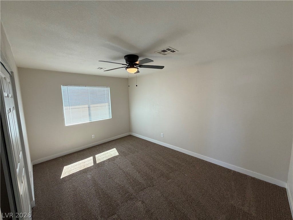 500 Grimsby Avenue, Henderson, NV 89014 Natural light streams across the carpeted floor of this versatile bedroom space.
