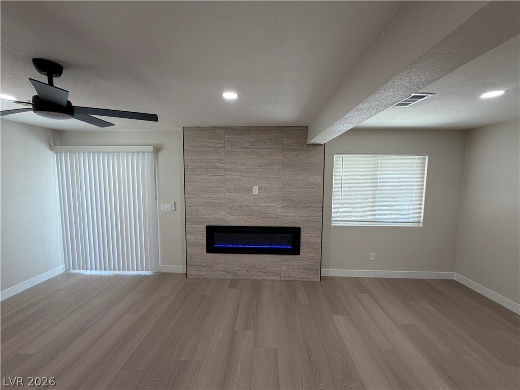 500 Grimsby Avenue, Henderson, NV 89014 Sleek hardwood floors and a modern linear fireplace anchor this open living space.