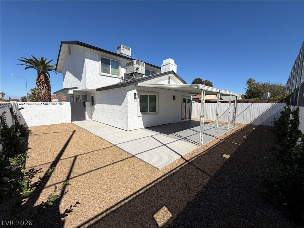 500 Grimsby Avenue, Henderson, NV 89014 An inviting covered patio and concrete walkway enhance this low-maintenance gravel backyard space.