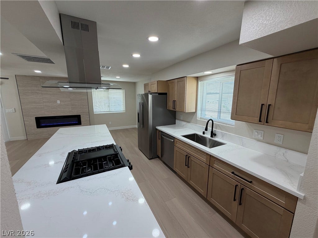 500 Grimsby Avenue, Henderson, NV 89014 Gleaming stone countertops and matching light wood cabinetry define this modern culinary workspace.