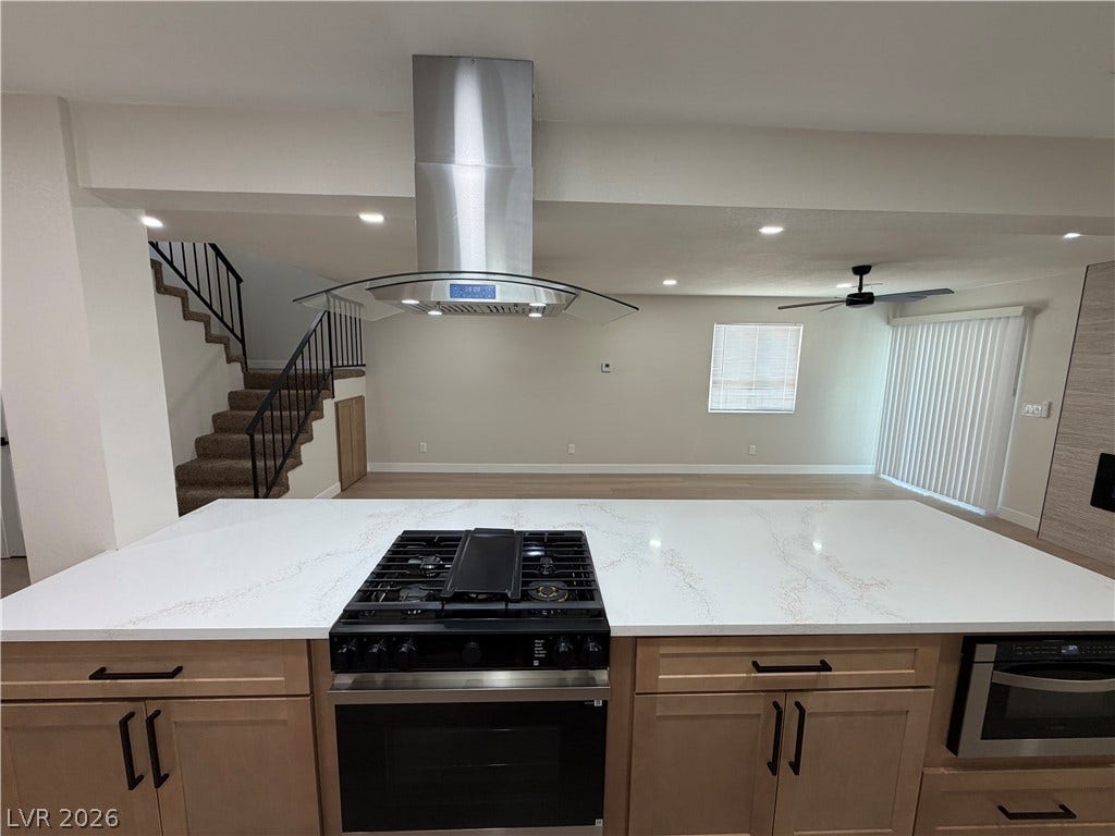 500 Grimsby Avenue, Henderson, NV 89014 An open floorplan seamlessly connects the stone-countertop kitchen island to the living area.