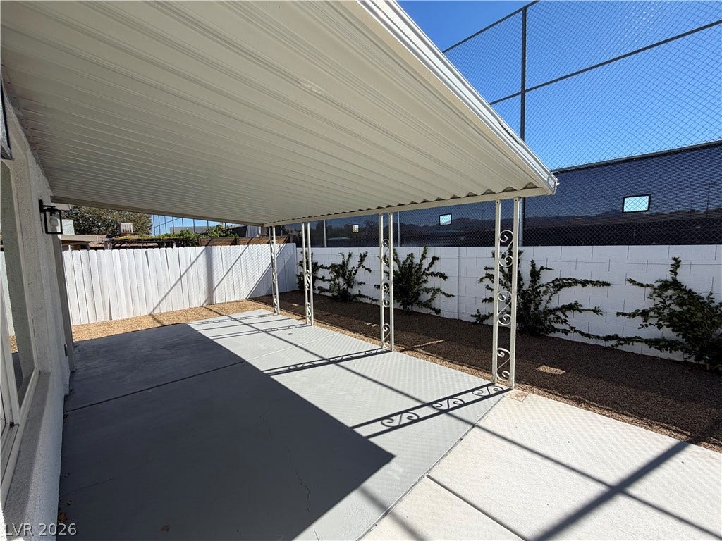 500 Grimsby Avenue, Henderson, NV 89014 A spacious covered concrete patio provides sheltered outdoor living space adjacent to the fenced yard.