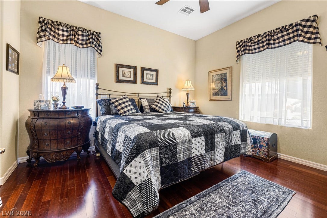 2107 Noah Tyler Ct., Henderson, NV 89052 Gleaming hardwood floors and towering windows elevate this comfortable bedroom retreat.