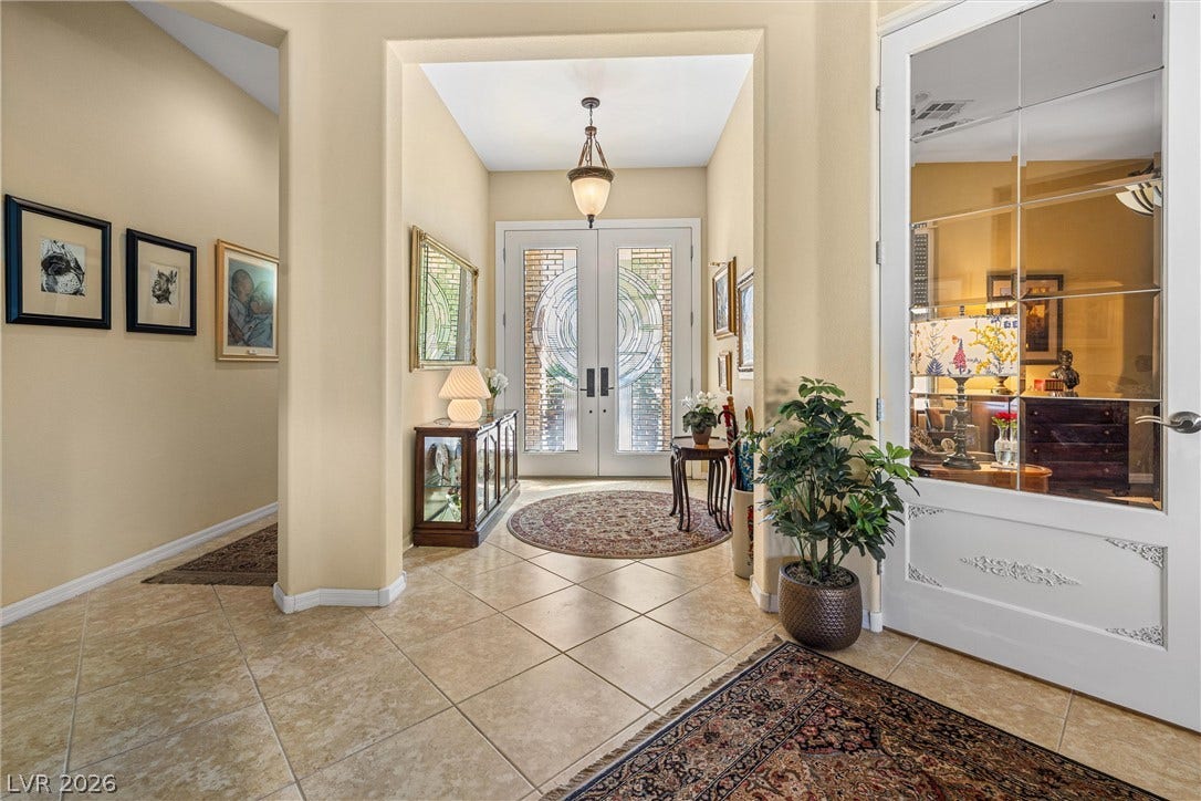 2107 Noah Tyler Ct., Henderson, NV 89052 Double entry doors with decorative glass panels open into a tiled foyer with high ceilings.