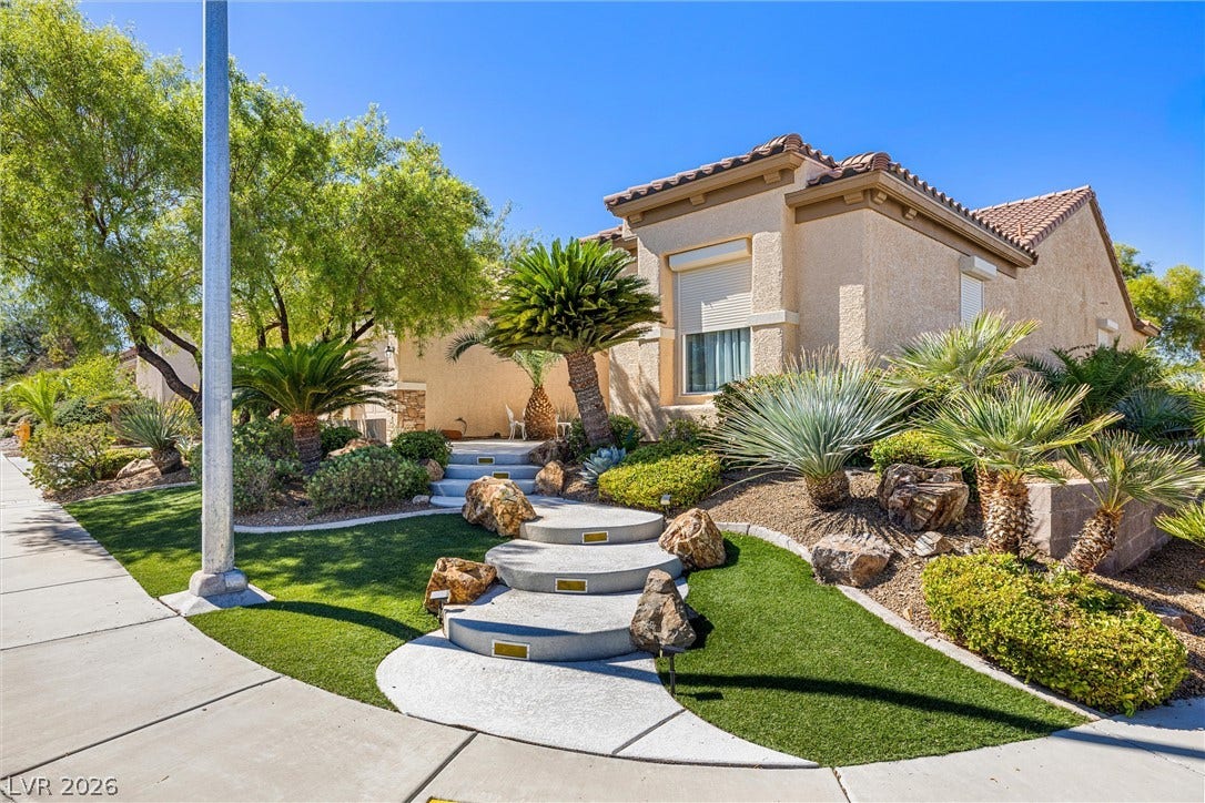 2107 Noah Tyler Ct., Henderson, NV 89052 Lush desert landscaping and a curving concrete path welcome you to this elegant stucco home.