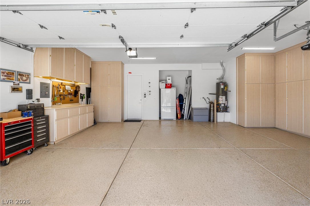 2107 Noah Tyler Ct., Henderson, NV 89052 An organized garage features seamless epoxy flooring and abundant built-in storage cabinets.