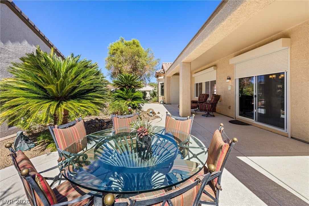 2107 Noah Tyler Ct., Henderson, NV 89052 An inviting covered patio offers seamless indoor-outdoor transition through sliding glass doors.