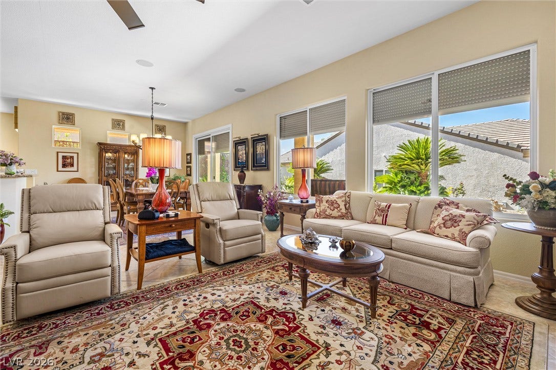 2107 Noah Tyler Ct., Henderson, NV 89052 Towering ceilings and wall-to-wall windows define this grand open-concept living room.