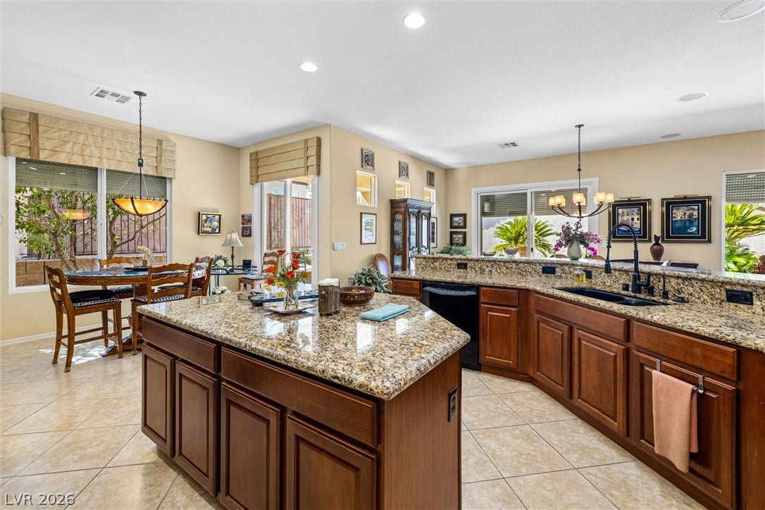 2107 Noah Tyler Ct., Henderson, NV 89052 Polished granite countertops and classic wood cabinetry enrich this open culinary space.
