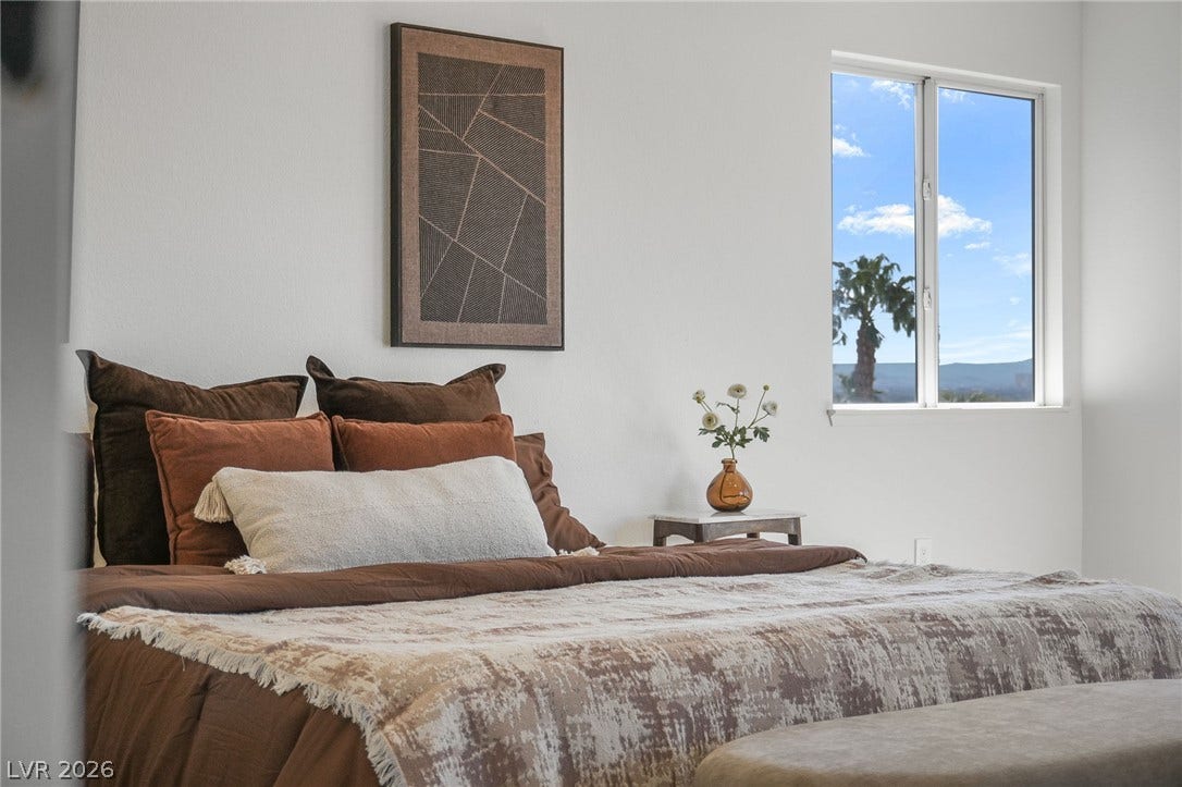 1287 Lime Point Street, Las Vegas, NV 89110 A tall sliding window frames beautiful blue skies and desert views from this tranquil bedroom.