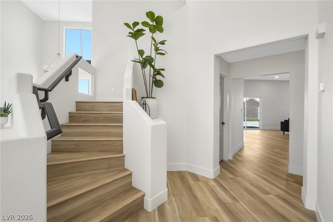 1287 Lime Point Street, Las Vegas, NV 89110 Clean lines and warm wood-style flooring define this welcoming split-level entryway.