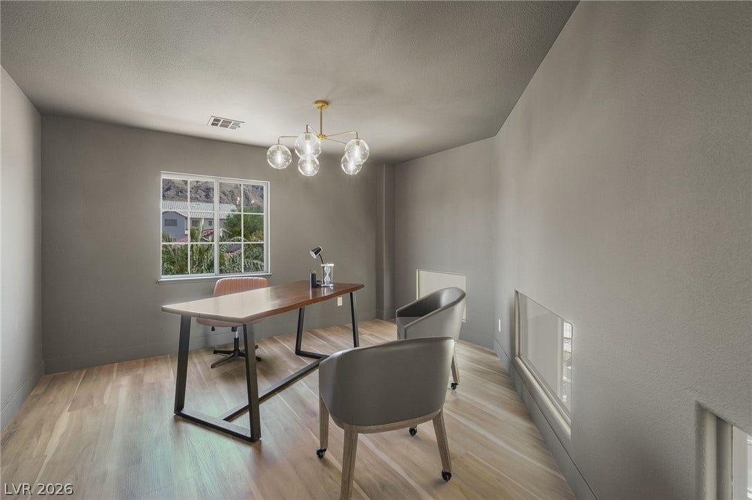 1287 Lime Point Street, Las Vegas, NV 89110 Natural light pours through multipane windows onto clean wood floors in this modern workspace.
