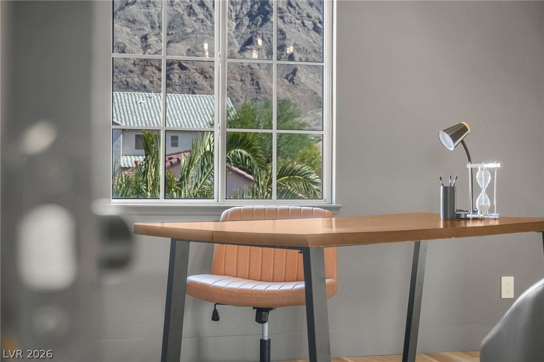1287 Lime Point Street, Las Vegas, NV 89110 Multi-pane windows frame majestic mountain and palm views from this quiet workspace.