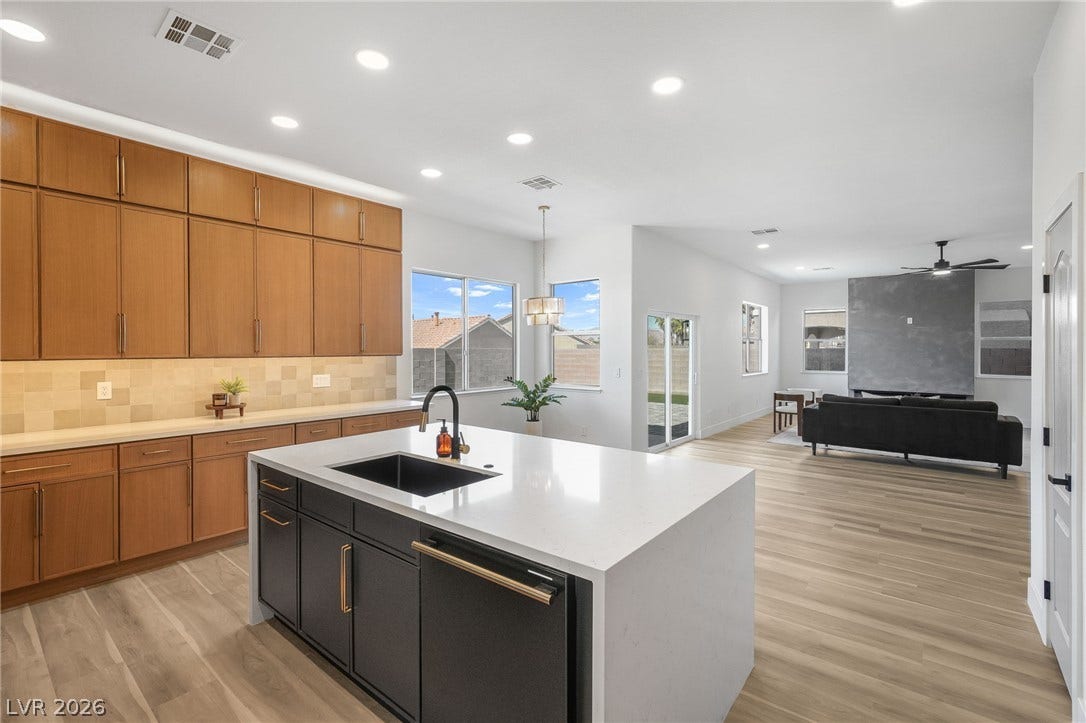 1287 Lime Point Street, Las Vegas, NV 89110 An open floorplan seamlessly connects the modern kitchen and airy living area.