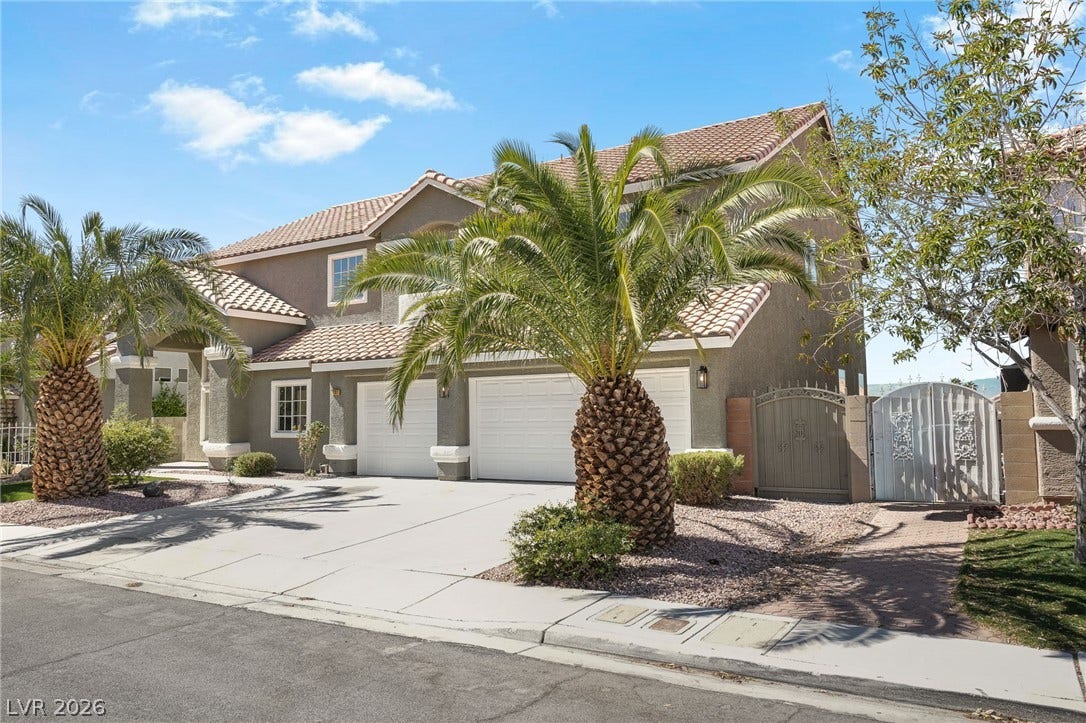 1287 Lime Point Street, Las Vegas, NV 89110 Mature palm trees frame a two-story exterior featuring arched entryways and a tile roof.