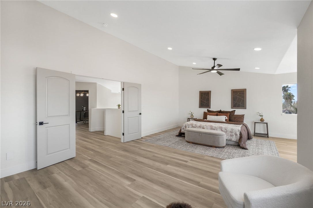 1287 Lime Point Street, Las Vegas, NV 89110 Double doors open to a generous bedroom featuring recessed lighting and wood-toned flooring.