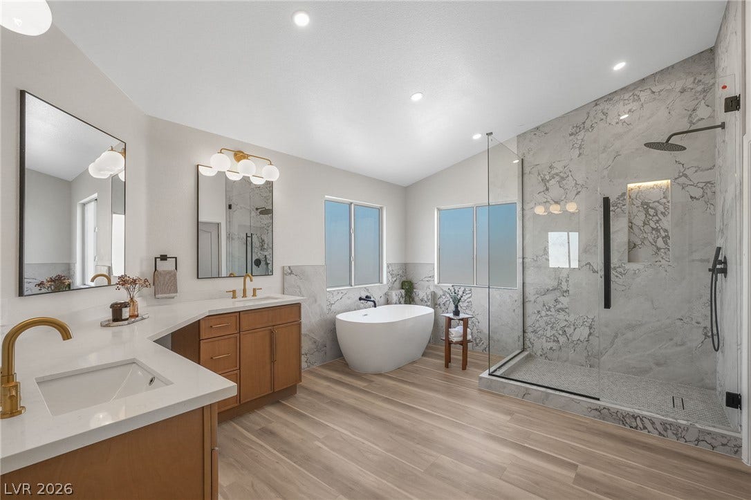 1287 Lime Point Street, Las Vegas, NV 89110 An elegant master bath features a freestanding tub, double vanity, and custom tiled shower.