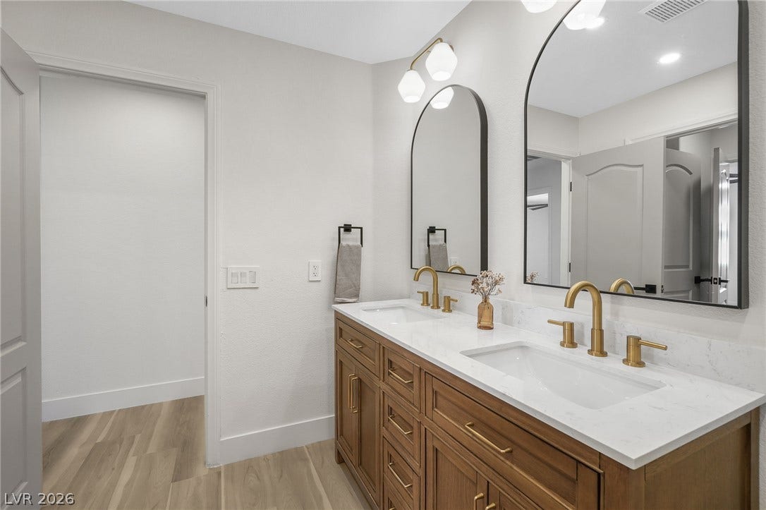 1287 Lime Point Street, Las Vegas, NV 89110 Arched mirrors and dual sinks create a highly functional main bath vanity.