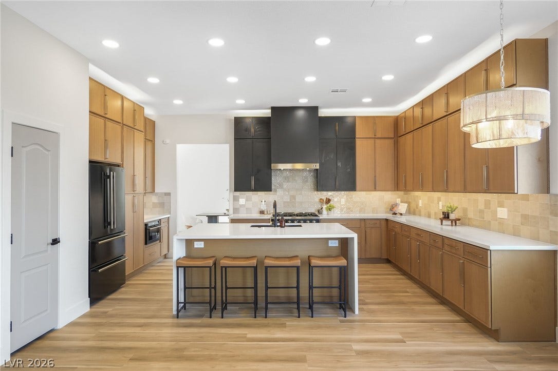 1287 Lime Point Street, Las Vegas, NV 89110 Gleaming stone countertops and abundant cabinetry define this modern kitchen with a central island.