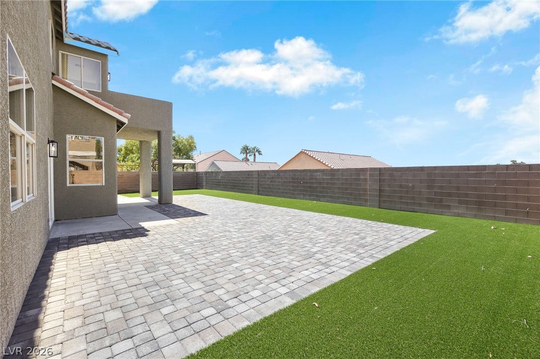 1287 Lime Point Street, Las Vegas, NV 89110 An expansive paver patio overlooks the manicured lawn enclosed by privacy fencing.