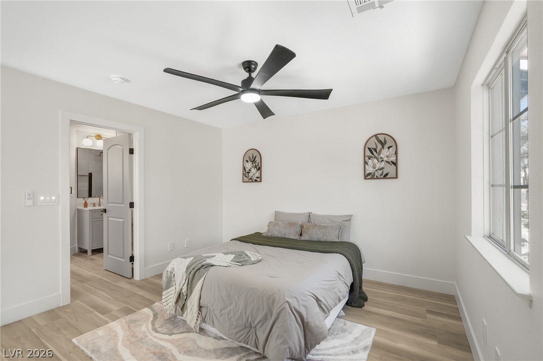 1287 Lime Point Street, Las Vegas, NV 89110 Smooth wood floors and an attached private bath define this comfortable bedroom space.