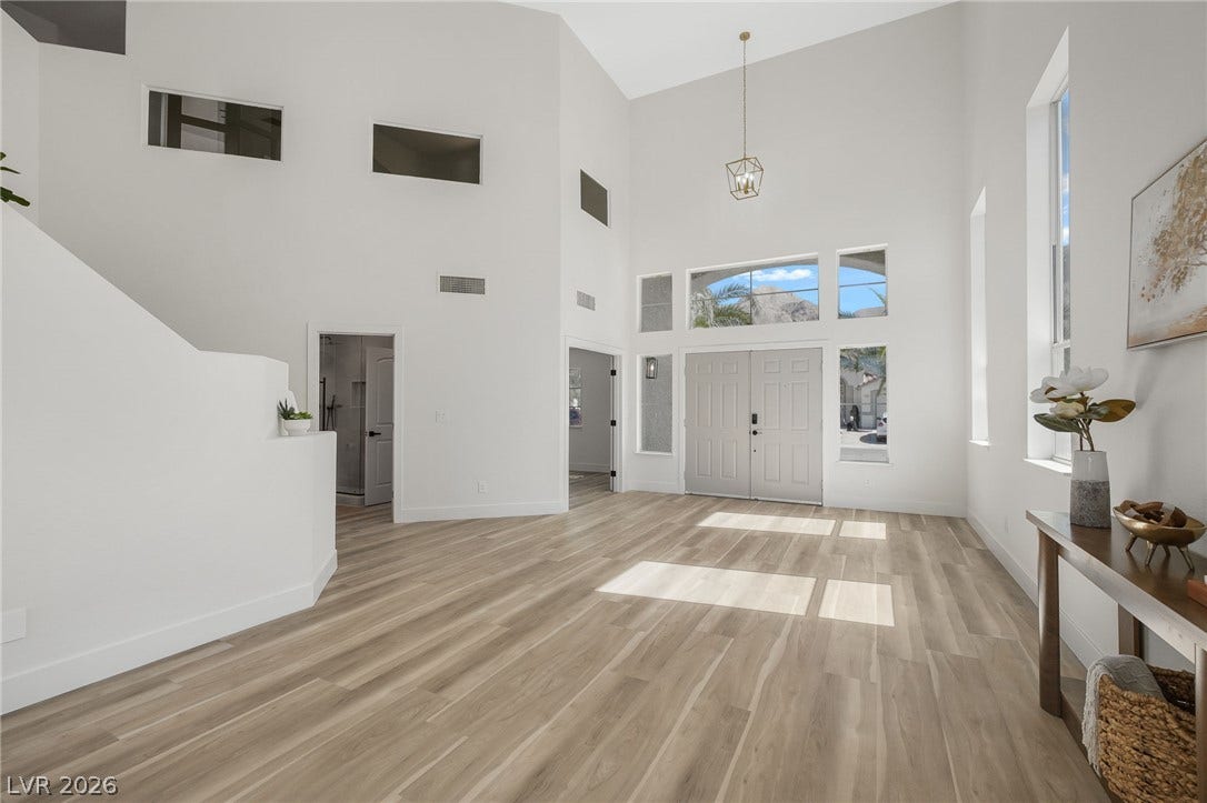 1287 Lime Point Street, Las Vegas, NV 89110 Soaring ceilings and warm wood floors define this architectural foyer entrance.
