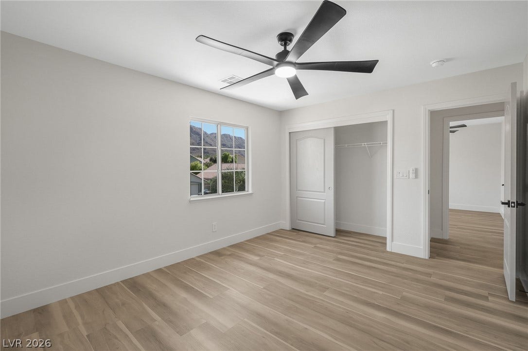 1287 Lime Point Street, Las Vegas, NV 89110 Smooth wood-style flooring and natural light elevate this versatile secondary bedroom space.