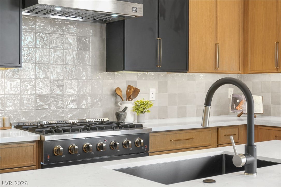 1287 Lime Point Street, Las Vegas, NV 89110 Sleek countertops and a tiled backsplash elevate this modern culinary space.