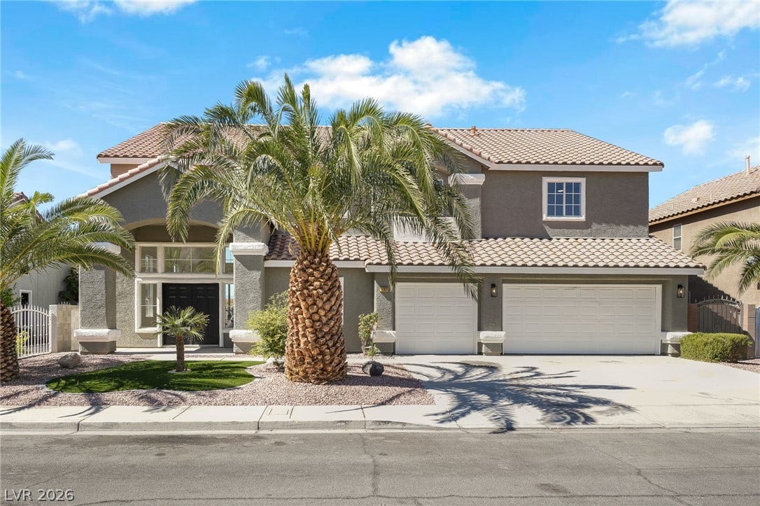 1287 Lime Point Street, Las Vegas, NV 89110 Palm trees frame the arched entryway and tiled rooflines of this classic two-story residence.