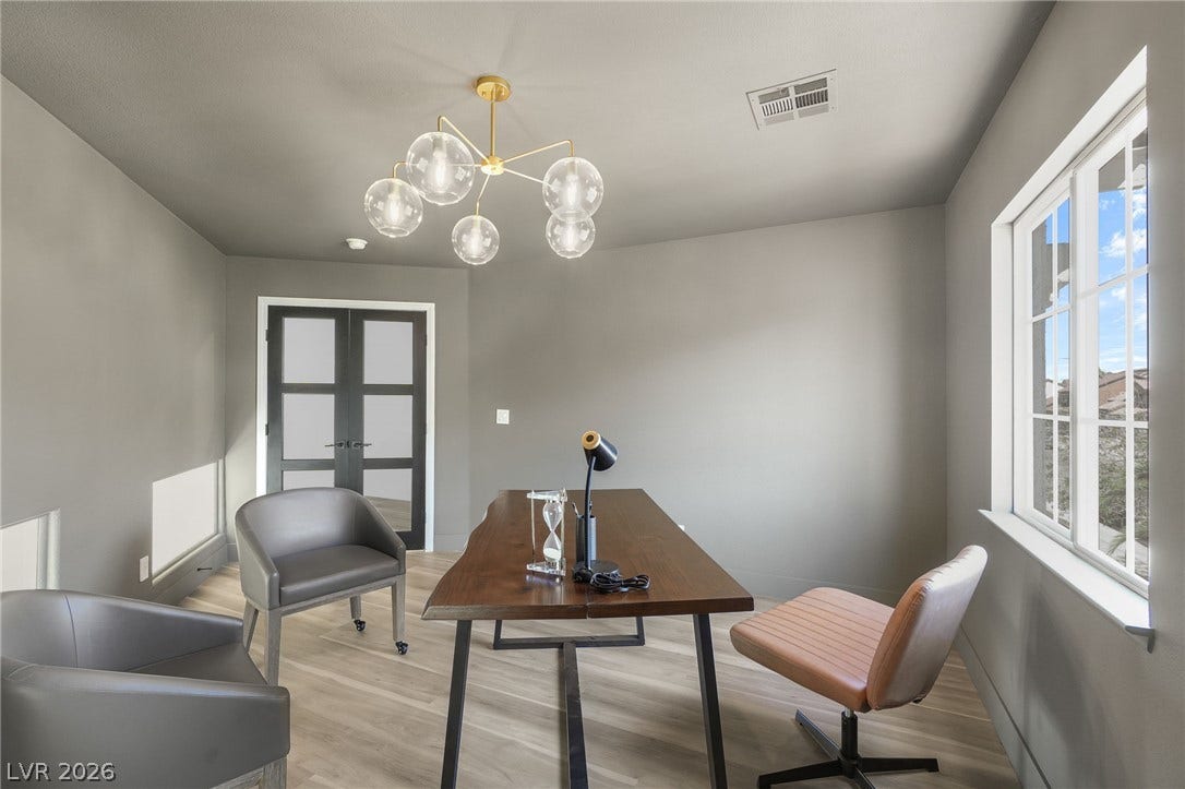 1287 Lime Point Street, Las Vegas, NV 89110 Double glass doors open into a bright home office featuring modern wood-look flooring.