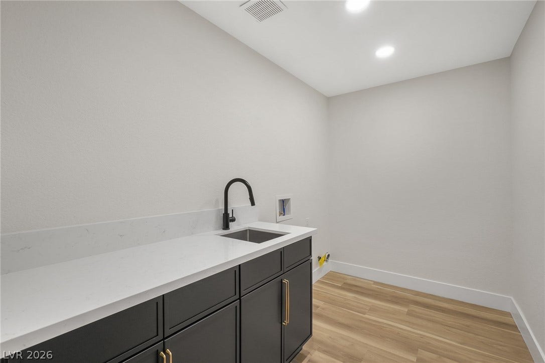 1287 Lime Point Street, Las Vegas, NV 89110 Clean lines and warm wood floors define this utility space with built-in cabinetry.