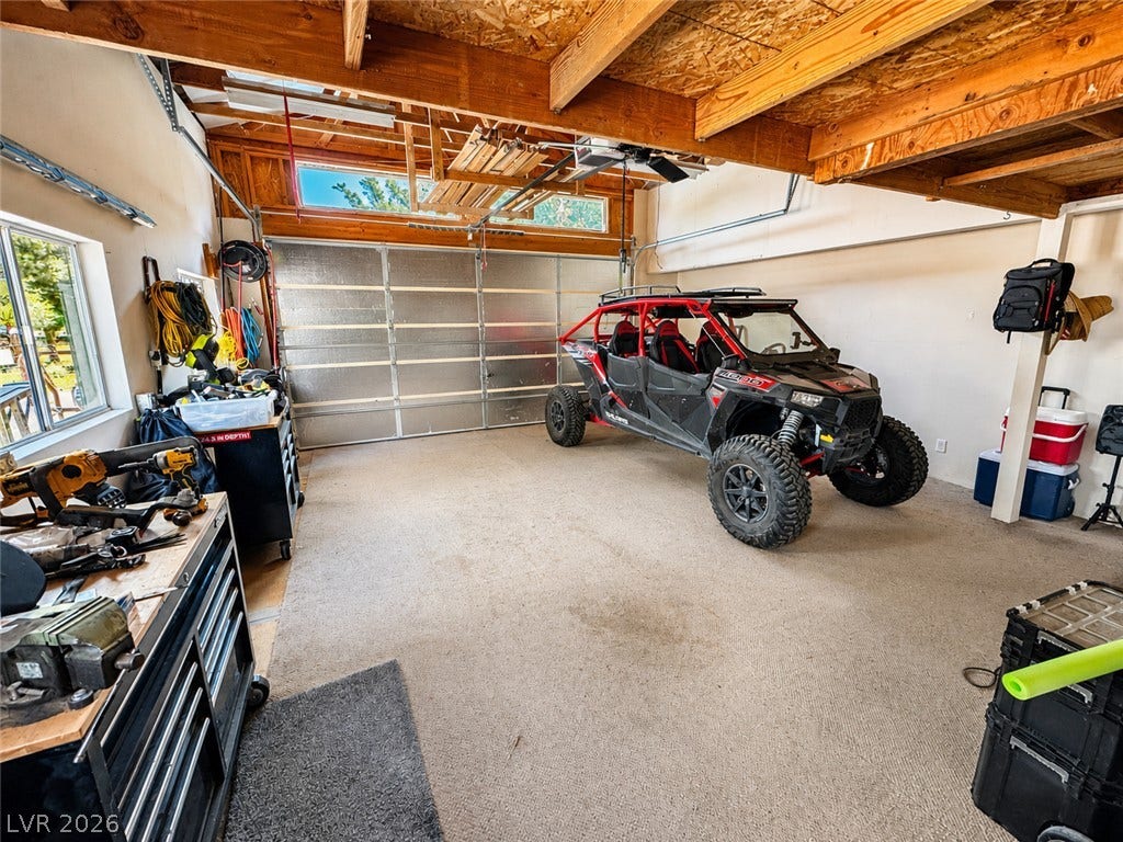 6130 Hawkins Way, Pahrump, NV 89061 Exposed wood beams and concrete floors define this highly functional garage space.