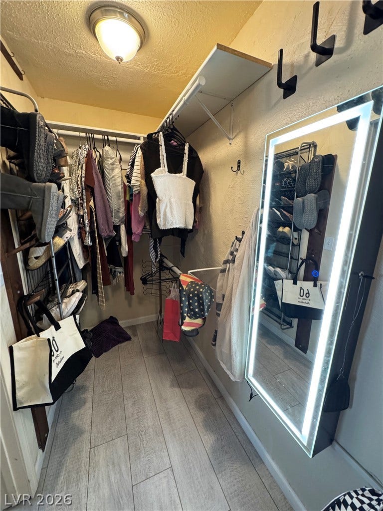 6130 Hawkins Way, Pahrump, NV 89061 A well-organized walk-in closet boasts durable wood-look flooring and integrated shelving.