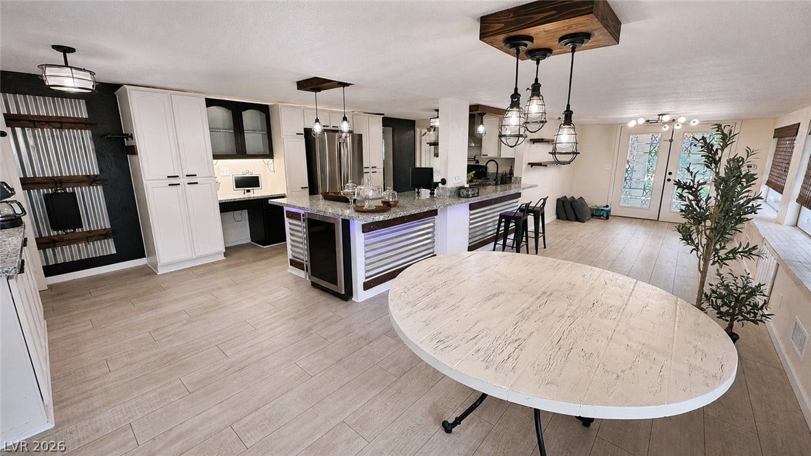 6130 Hawkins Way, Pahrump, NV 89061 An open kitchen layout transitions seamlessly into a bright dining area with light wood-style flooring.