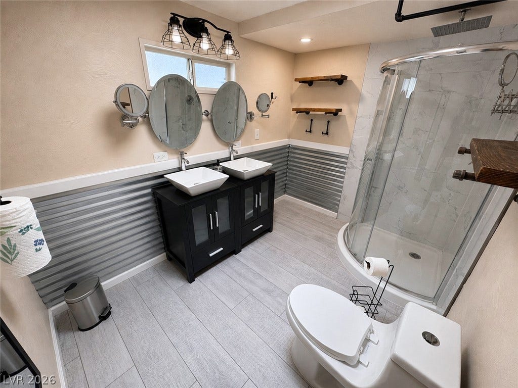 6130 Hawkins Way, Pahrump, NV 89061 Industrial details and sleek modern finishes define this fully renovated bathroom.