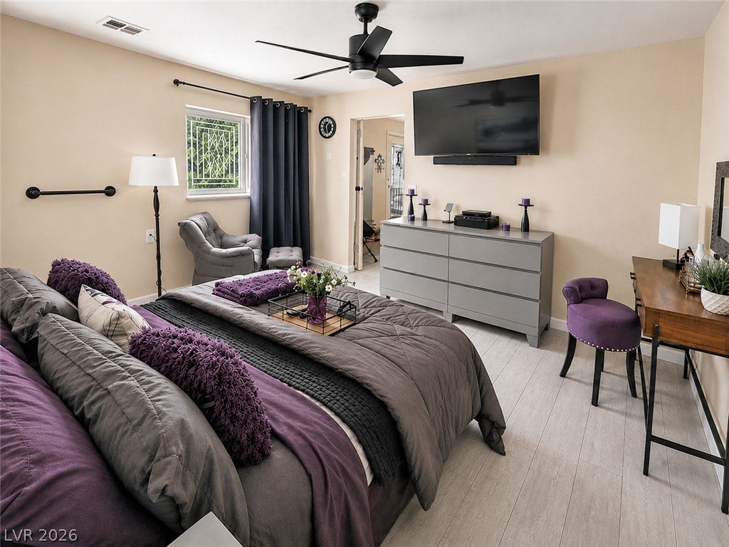 6130 Hawkins Way, Pahrump, NV 89061 Light-colored wood flooring anchors this comfortable bedroom suite complete with a private bath entrance.
