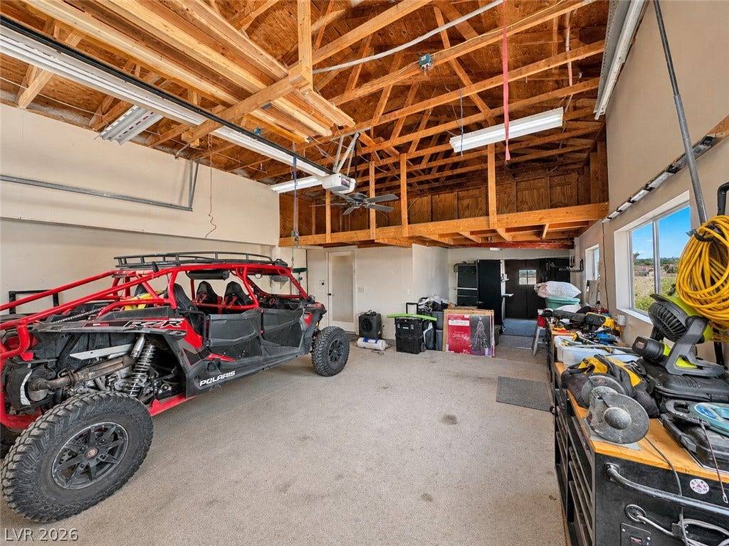6130 Hawkins Way, Pahrump, NV 89061 An expansive garage space features soaring exposed wood rafter ceilings and integrated overhead storage.