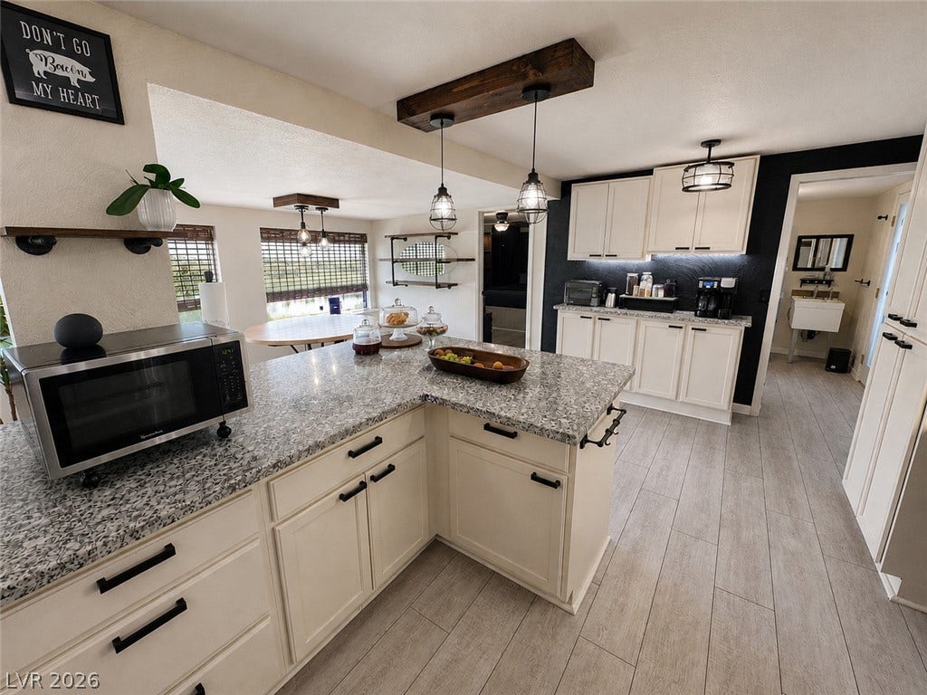 6130 Hawkins Way, Pahrump, NV 89061 Polished stone counters and durable wood-look tile floors anchor this well-appointed workspace.