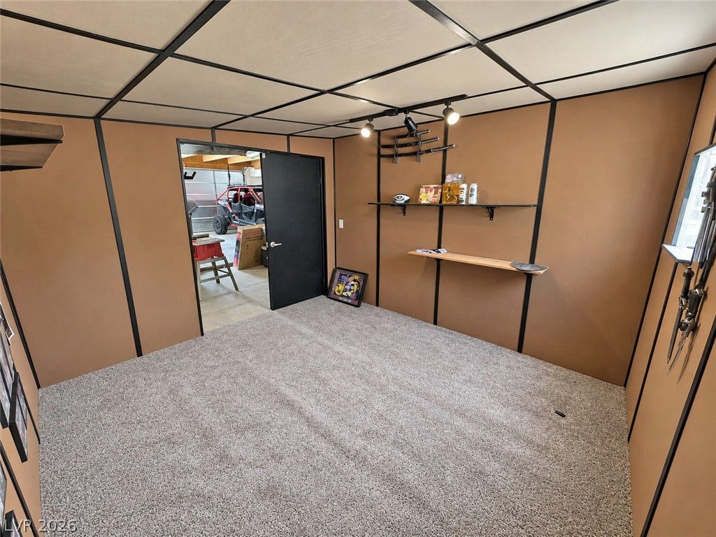 6130 Hawkins Way, Pahrump, NV 89061 Plush carpeting and paneled walls define this versatile bonus room adjoining the garage.