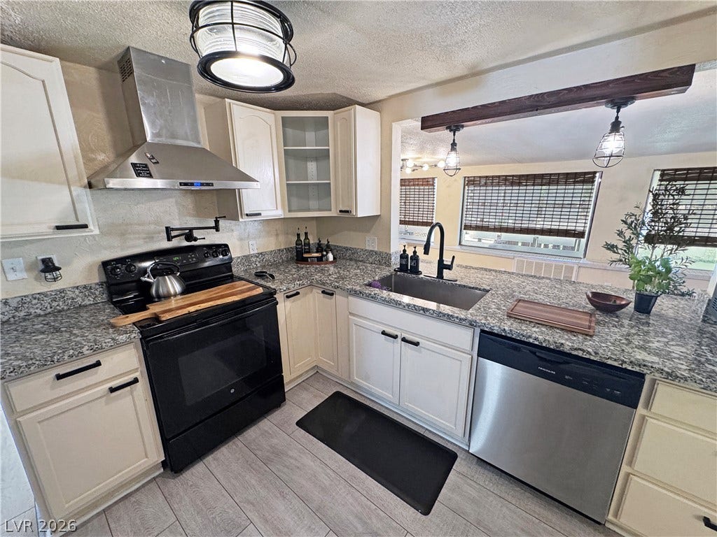 6130 Hawkins Way, Pahrump, NV 89061 Granite countertops and sleek stainless steel appliances anchor this modern culinary workspace.