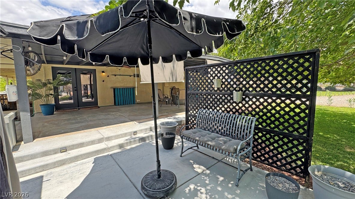 6130 Hawkins Way, Pahrump, NV 89061 Concrete patios lead to a covered outdoor lounge area perfect for entertaining.