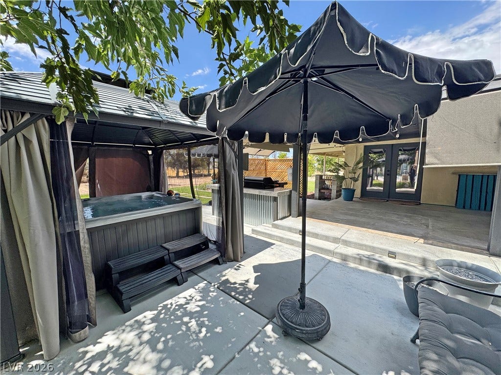 6130 Hawkins Way, Pahrump, NV 89061 Concrete patio spaces wrap around a private hot tub under a covered gazebo structure.