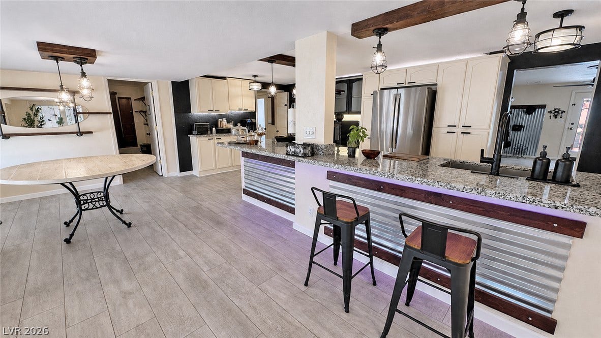 6130 Hawkins Way, Pahrump, NV 89061 Gleaming stone countertops and wood floor accents enrich this open-concept culinary space.