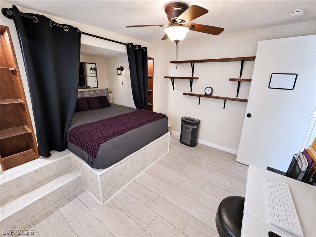 6130 Hawkins Way, Pahrump, NV 89061 Custom built-in shelving and light wood-look flooring enhance this uniquely designed private space.