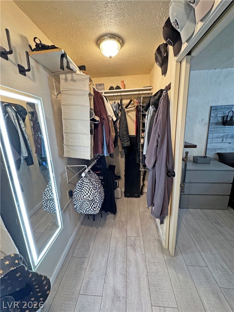 6130 Hawkins Way, Pahrump, NV 89061 A functional walk-in closet boasts durable wood-look flooring and custom hanging rods.