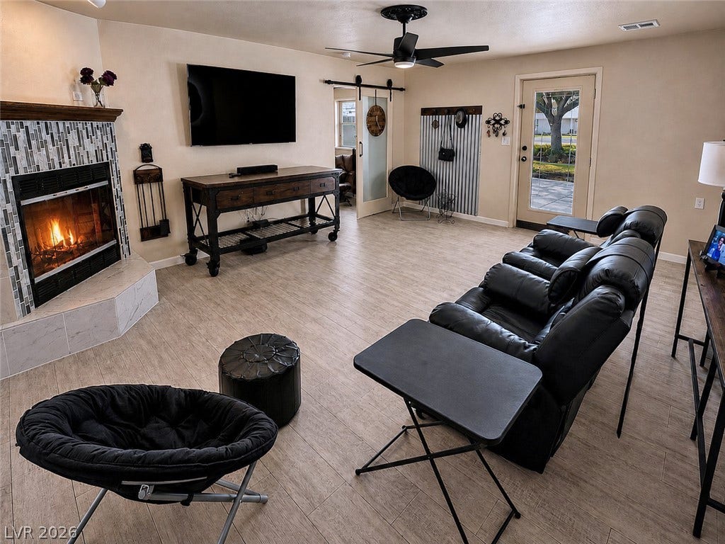 6130 Hawkins Way, Pahrump, NV 89061 An inviting fireplace with decorative tile surround anchors this spacious, light-filled living area.